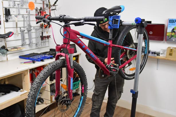 Like Bikes, Technician repairs bike